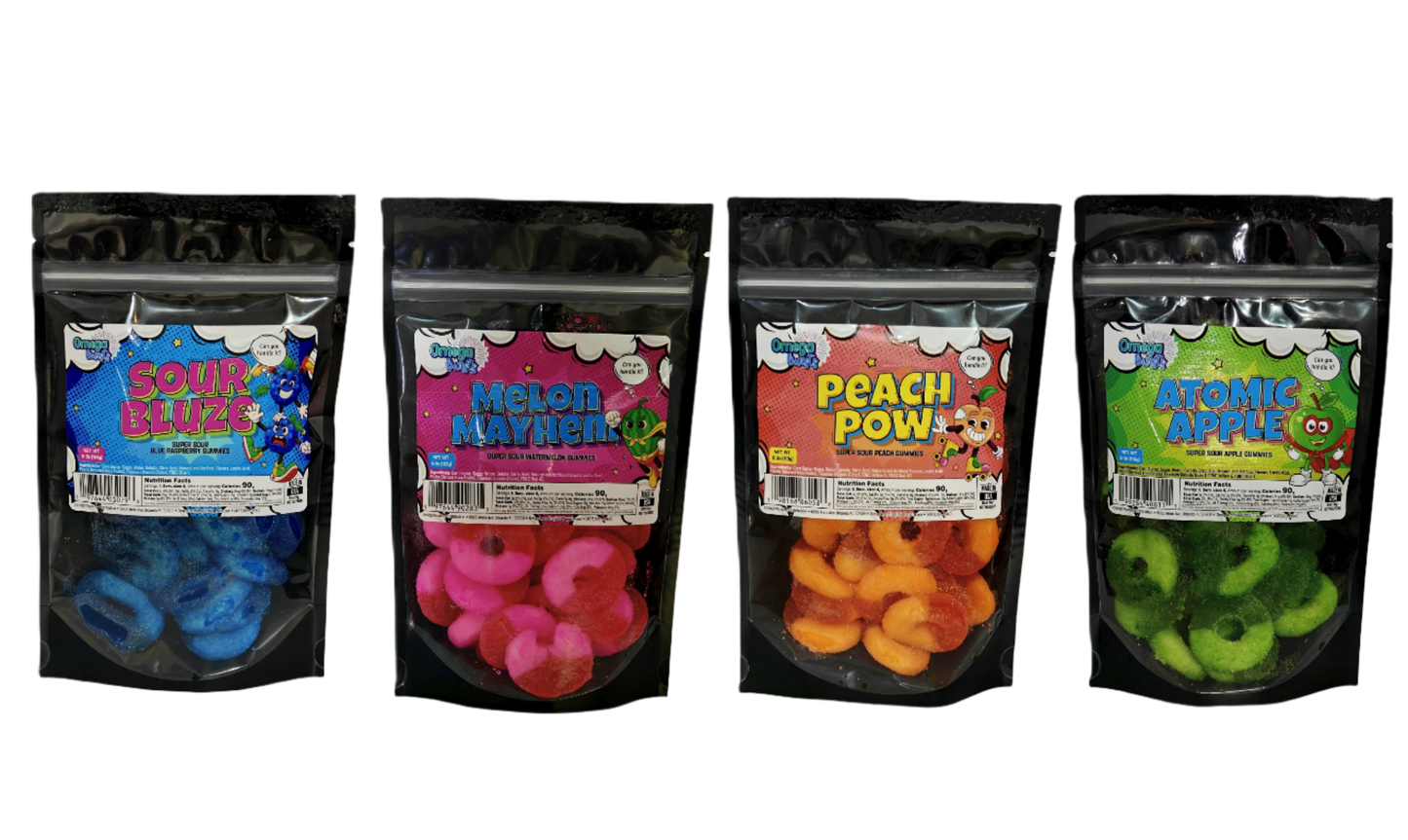 Four packages of gummy candies with colorful labels on a white background